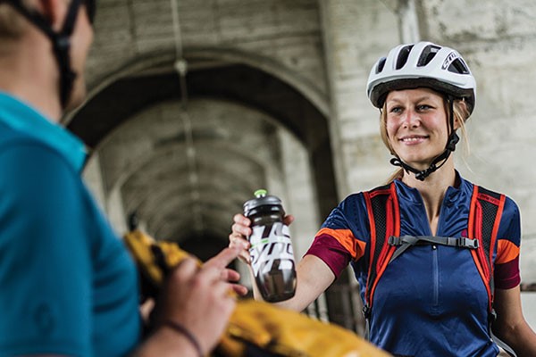 Cyclist sharing their drink